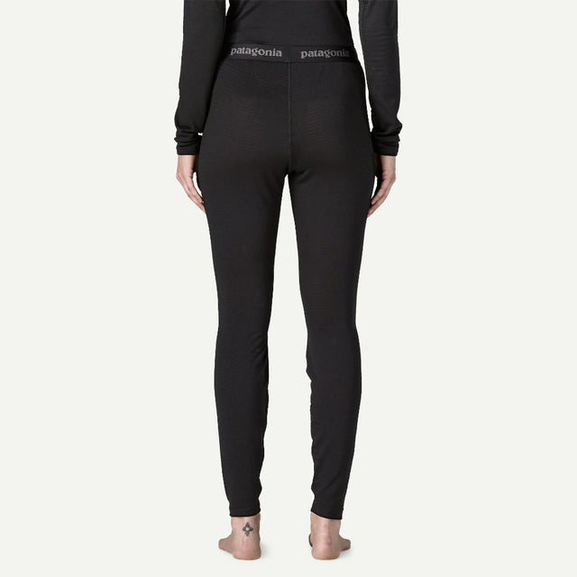 Back on-model view of Patagonia's capilene thermal weight bottoms women's in black colour