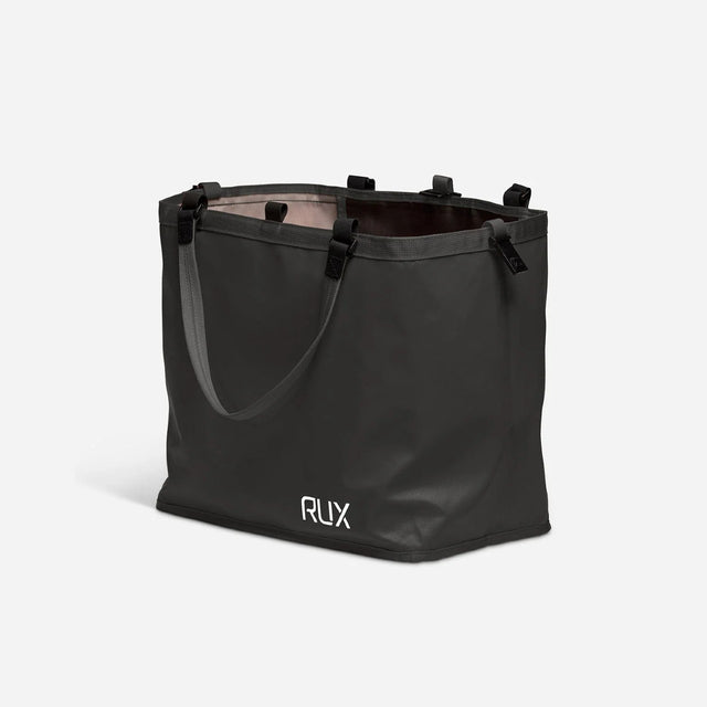 Side angled view of black RUX tote bag