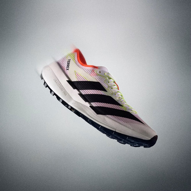 Adidas running shoe with colorful design on a gray background