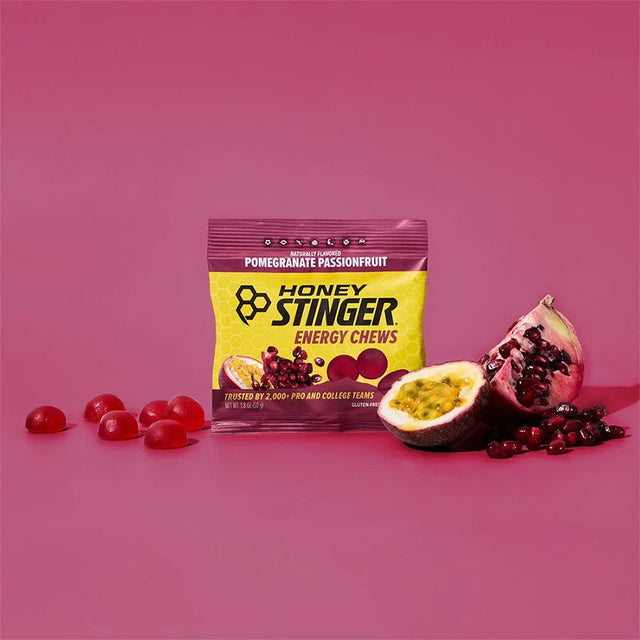 Honey Stinger energy chews package with pomegranate and passionfruit on a pink background