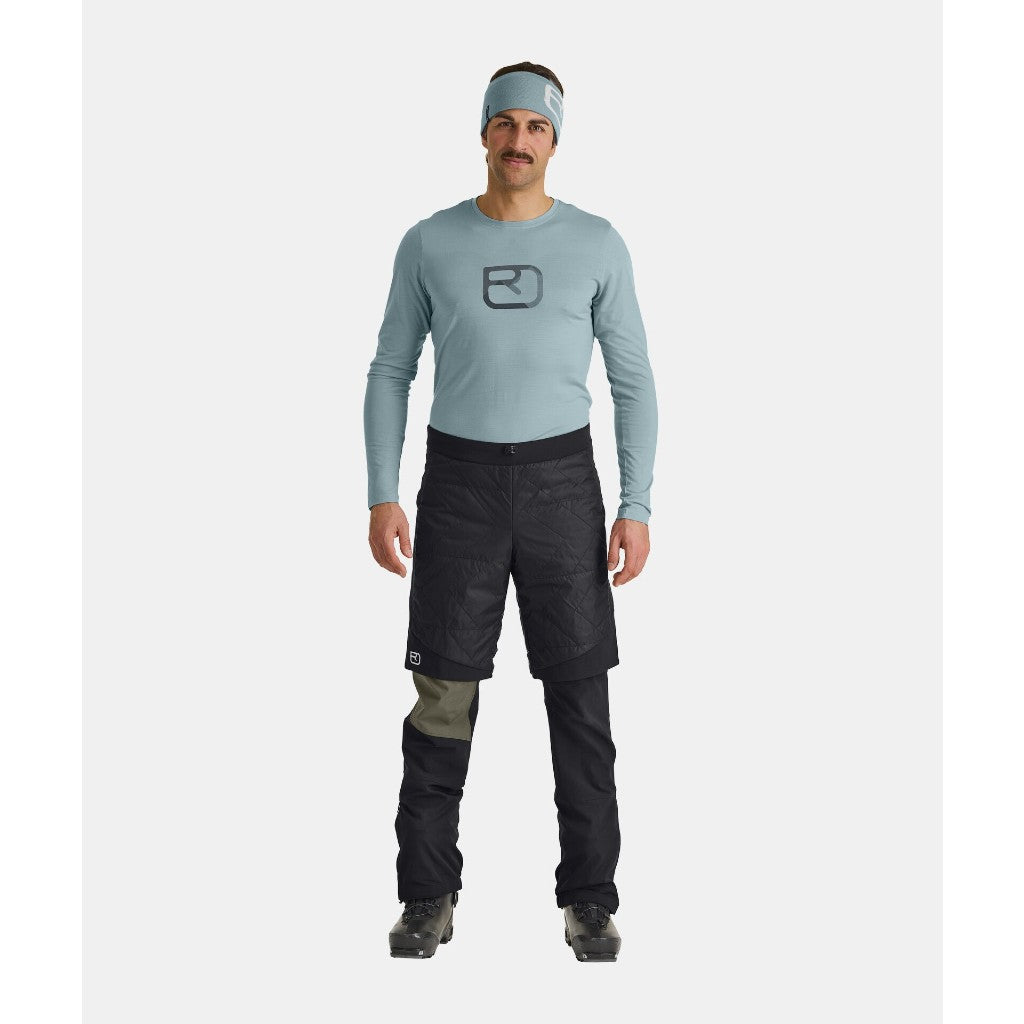 On-model view of men's black Ortovox Piz Boe insulated shorts