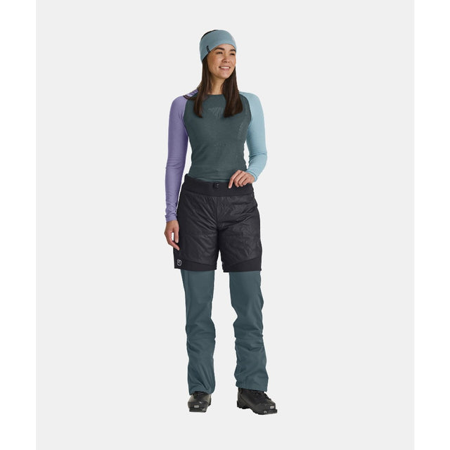 On-model view of women's black Ortovox Piz Boe insulated shorts