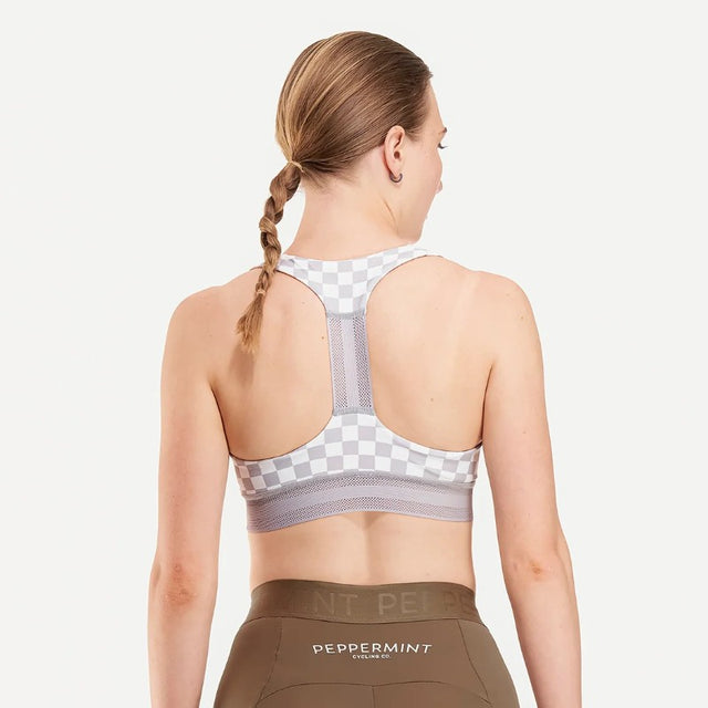Back on-model view of women's checkered grey/white Peppermint Cycling sports bra