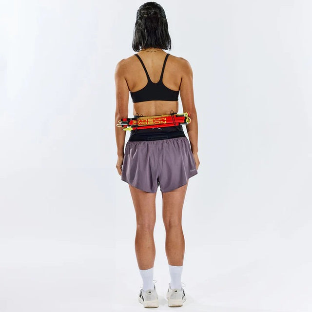 Person wearing Raide running belt with poles attached