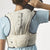Back on-model view of Salomon S/Lab Ultra 10 running vest in almond milk colour