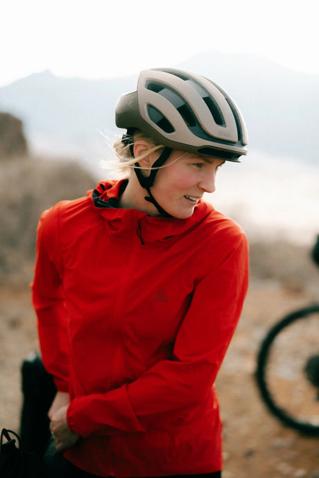 Biker wearing women's orange 7mesh northwoods windshell