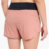 Back view of model with the ciele women's TRNShort 4" brief 2 in rose dawn colour