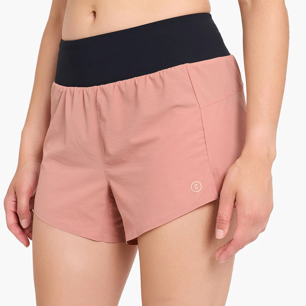 Front view of model with the ciele women's TRNShort 4" brief 2 in rose dawn colour