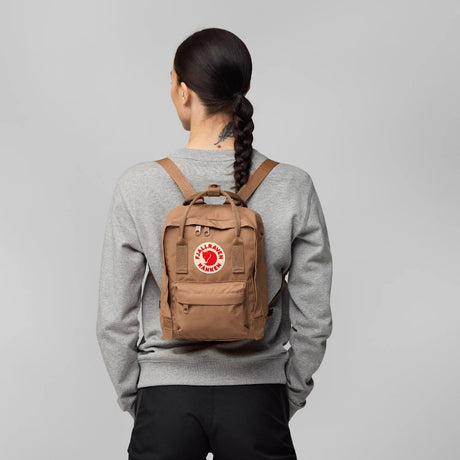 Model wearing the Fjallraven Kanken Mini backpack in Khaki dust colour
