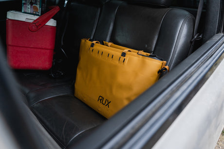 RUX bronze soft cooler bag on a car seat