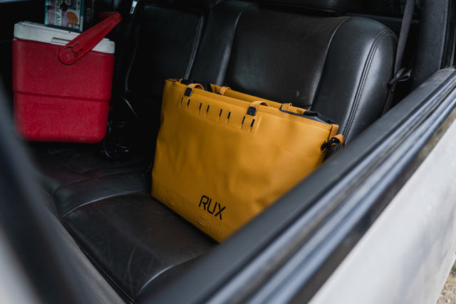 RUX bronze soft cooler bag on a car seat