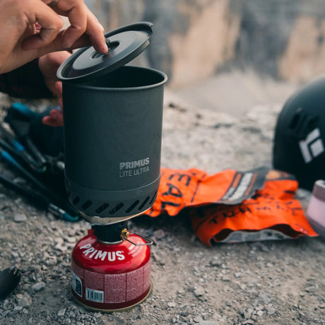 Primus Lite Ultra stove being used outdoors with a blurred background