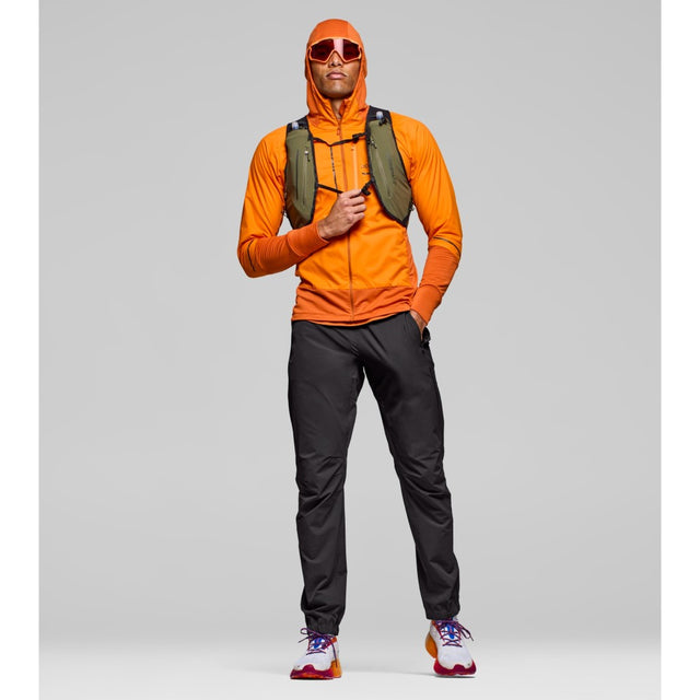 Front on-model view of Norrona Senja Flex1 Trackster pants for men in caviar black colour