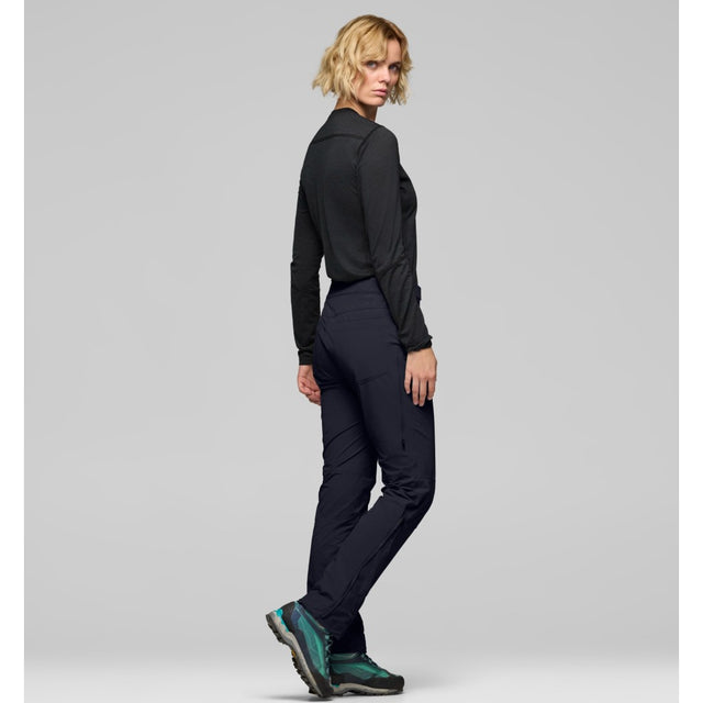 Side on-model view of Norrona femund Flex1 lightweight pants women's in caviar black colour