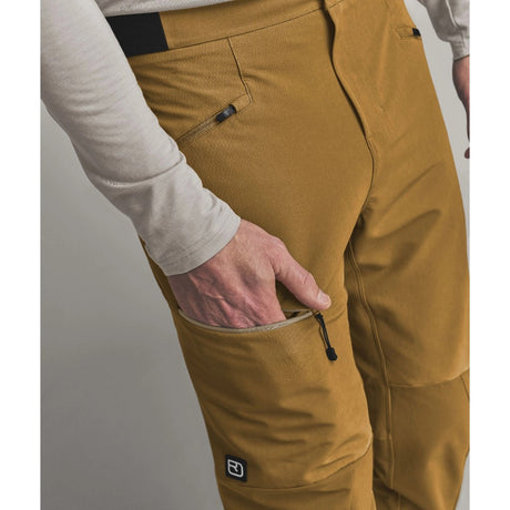 Pocket on-model view of Ortovox Ortler Softshell pants men's in dark cumin colour