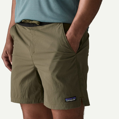 Front pocket detail on-model view of Patagonia baggies lights 6" men's in basin green colour