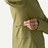 Pocket detail of on-model women's Patagonia's cap cool sun hoody in gumtree green