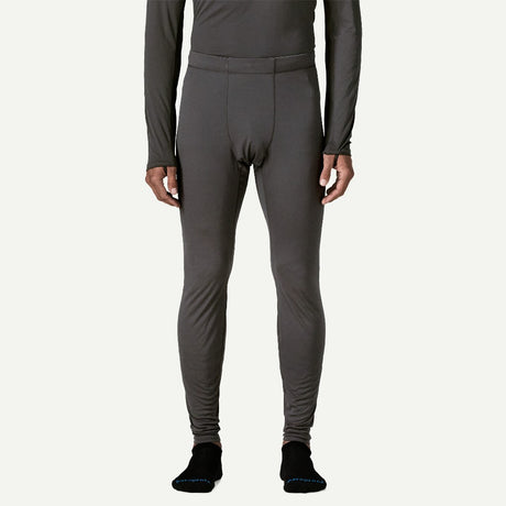 Front on-model view of Patagonia's Men Capilene Lightweight Bottoms in black colour