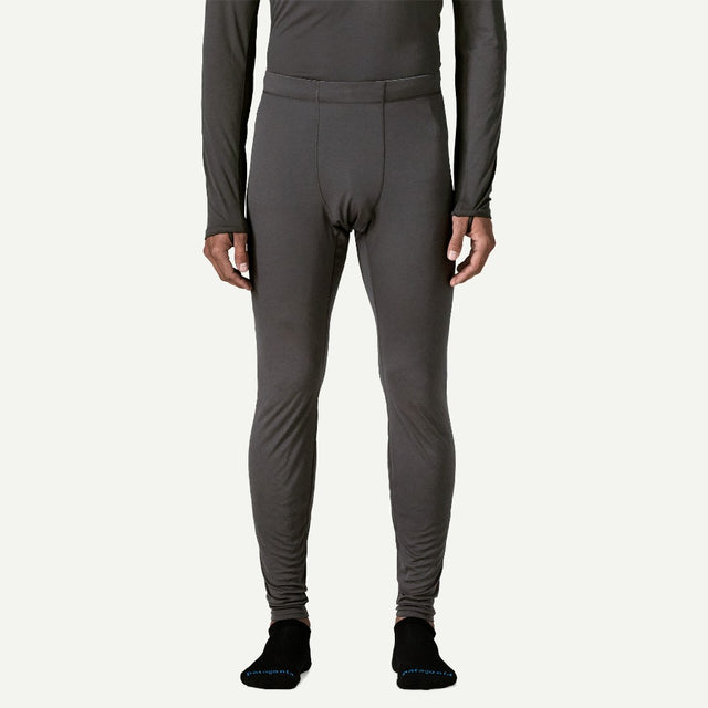 Front on-model view of Patagonia's Men Capilene Lightweight Bottoms in black colour
