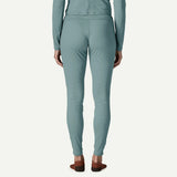 Back on-model view of Patagonia's Women Capilene Lightweight Bottoms in bluea sage colour