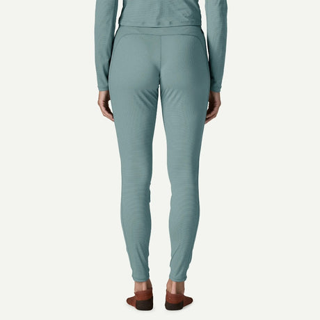 Back on-model view of Patagonia's Women Capilene Lightweight Bottoms in bluea sage colour