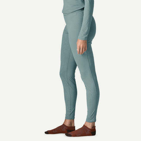 Side on-model view of Patagonia's Women Capilene Lightweight Bottoms in bluea sage colour