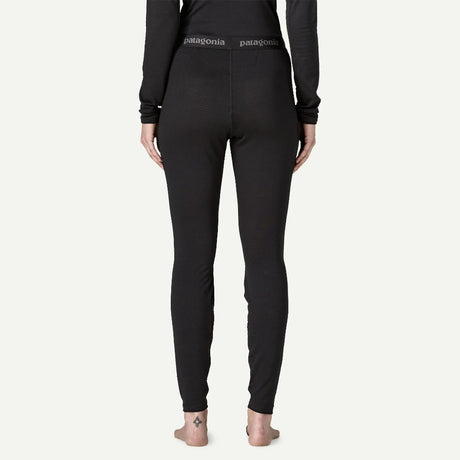 Back on-model view of Patagonia's capilene thermal weight bottoms women's in black colour