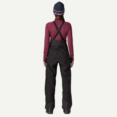 Back on-model view of Patagonia's Snow Drifter Bibs for women in black colour
