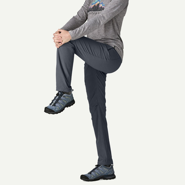 Stretch detail on-model of Patagonia Terravia Trail Pants women's in smolder blue colour