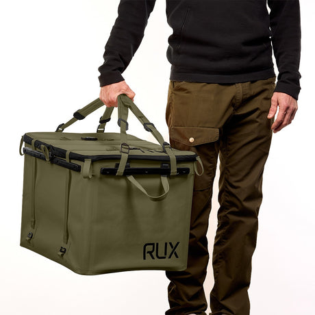 Person holding a green RUX bag with tote straps