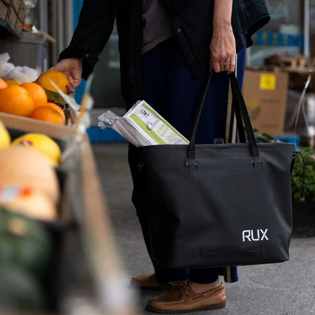 Person shopping for groceries with the RUX waterproof 30L tote bag