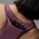 Pocket detail on-model view of Rabbit's hydration trail bra women's in hawthorn rose colour