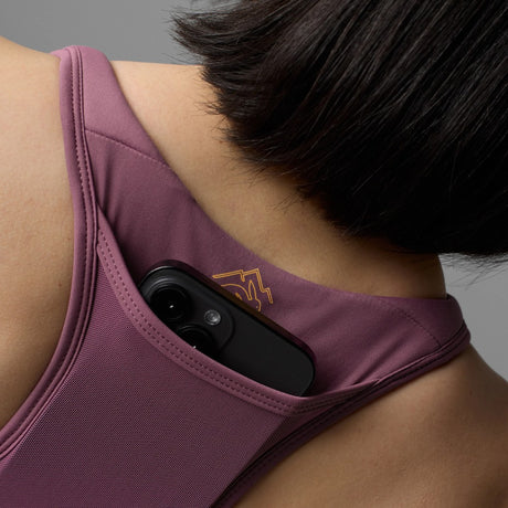Pocket detail on-model view of Rabbit's hydration trail bra women's in hawthorn rose colour