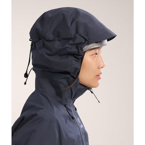 Hood on-model detail of women's Arc'teryx Beta AR Jacket in black sapphire colour (navy)