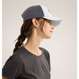 Side view of Arc'teryx Bird Trucker curved brim hat in daybreak/graphite colour