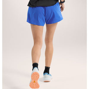 Back on-model view of women's vitality (blue) Arc'teryx Norvan 5" running shorts
