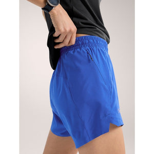 Side on-model view of women's vitality (blue) Arc'teryx Norvan 5" running shorts