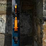 Orange/black ATK Newmark Lite telemark binding on a blue ski