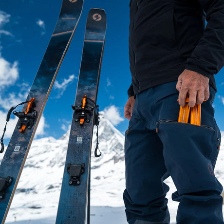 Packing the orange NTN module of the ATK Newmark Lite telemark binding into a pocket