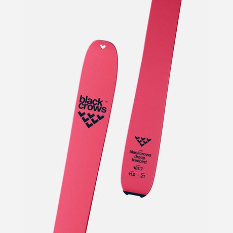 Tip and tail details of a pair of pink Black Crows Draco Freebird skis