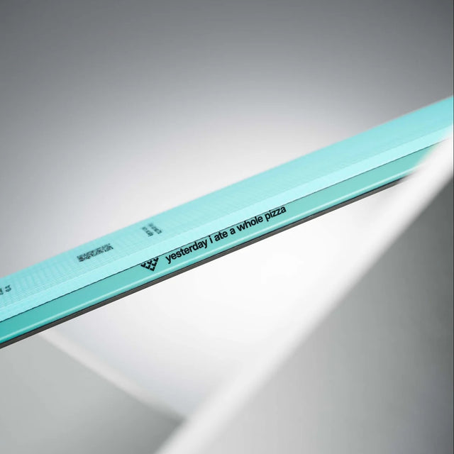 Side motto of a turquoise Black Crows Mentis Freebird ski - "yesterday i ate a whole pizza"