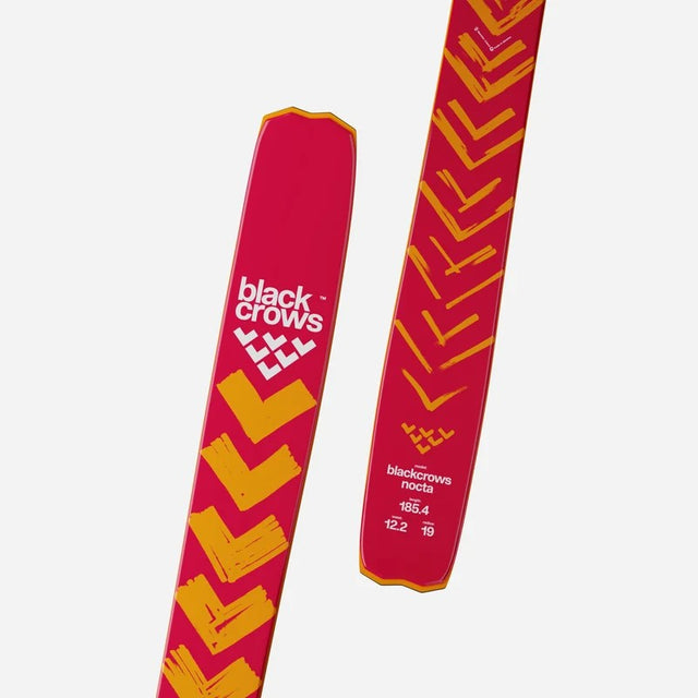 Tail and tip details of a pair of orange Black Crows Nocta skis