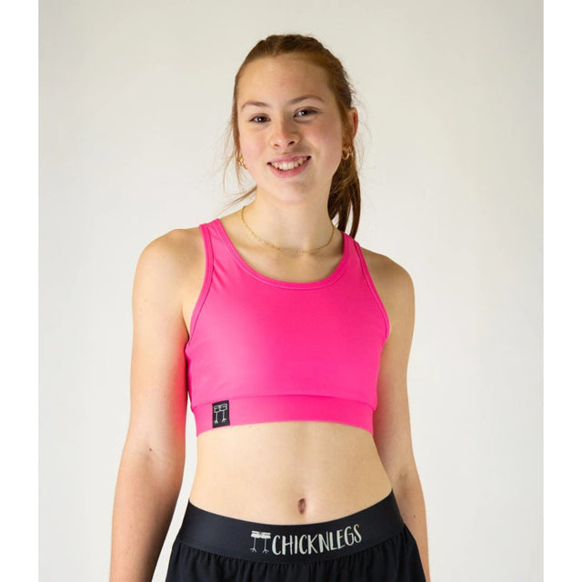 Front view of ChicknLegs OG sports bra in neon pink colour