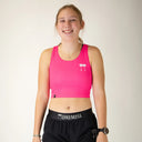 Front view of women's ChicknLegs PWR crop top in neon pink