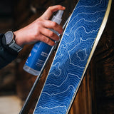 Applying contour climbing skin spray to a ski skin