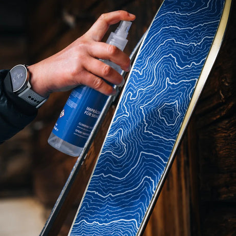 Applying contour climbing skin spray to a ski skin