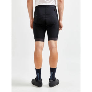 Back view on model of men's black Craft ADV Endur bike shorts