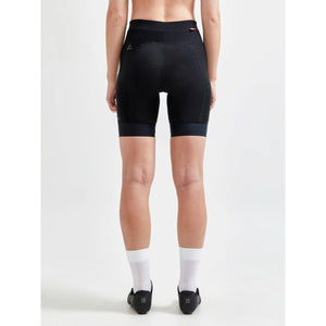 Back view on model of women's black Craft ADV Endur bike shorts