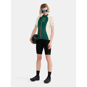 On-model view of women's Craft ADV gravel short-sleeve bike jersey in twig/plaster colour
