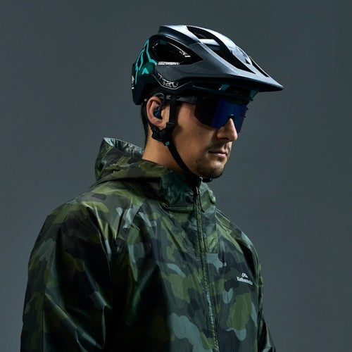 Biker wearing black earshots sports earbuds